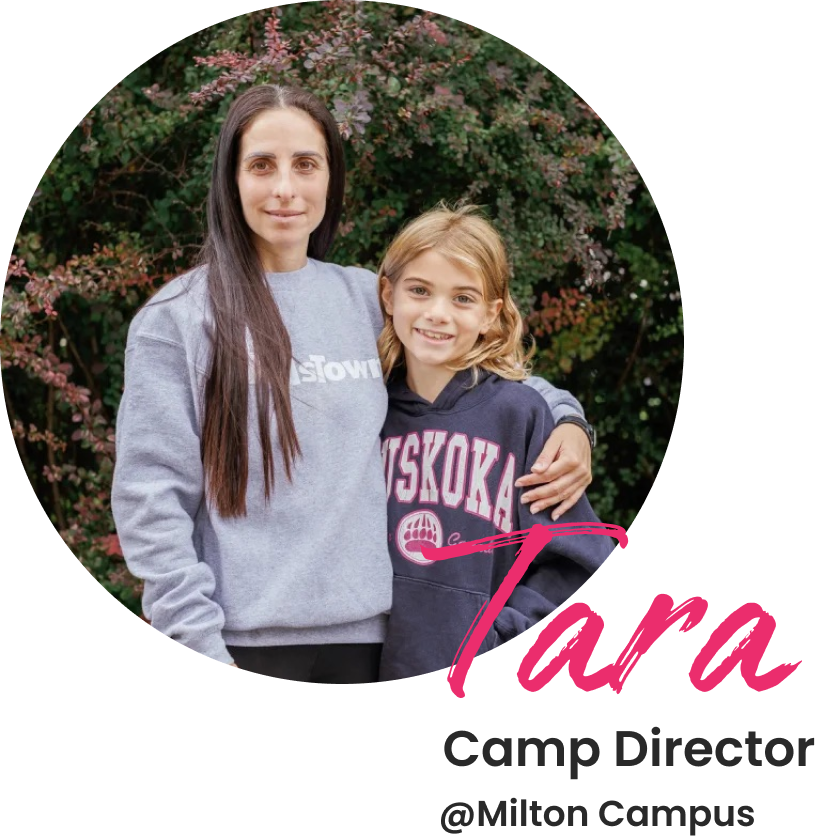 Camp Director, Tara standing beside one of the camper at Milton Campus.