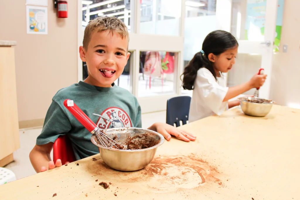 a Camp KidsTown Camper enjoying the baking camp